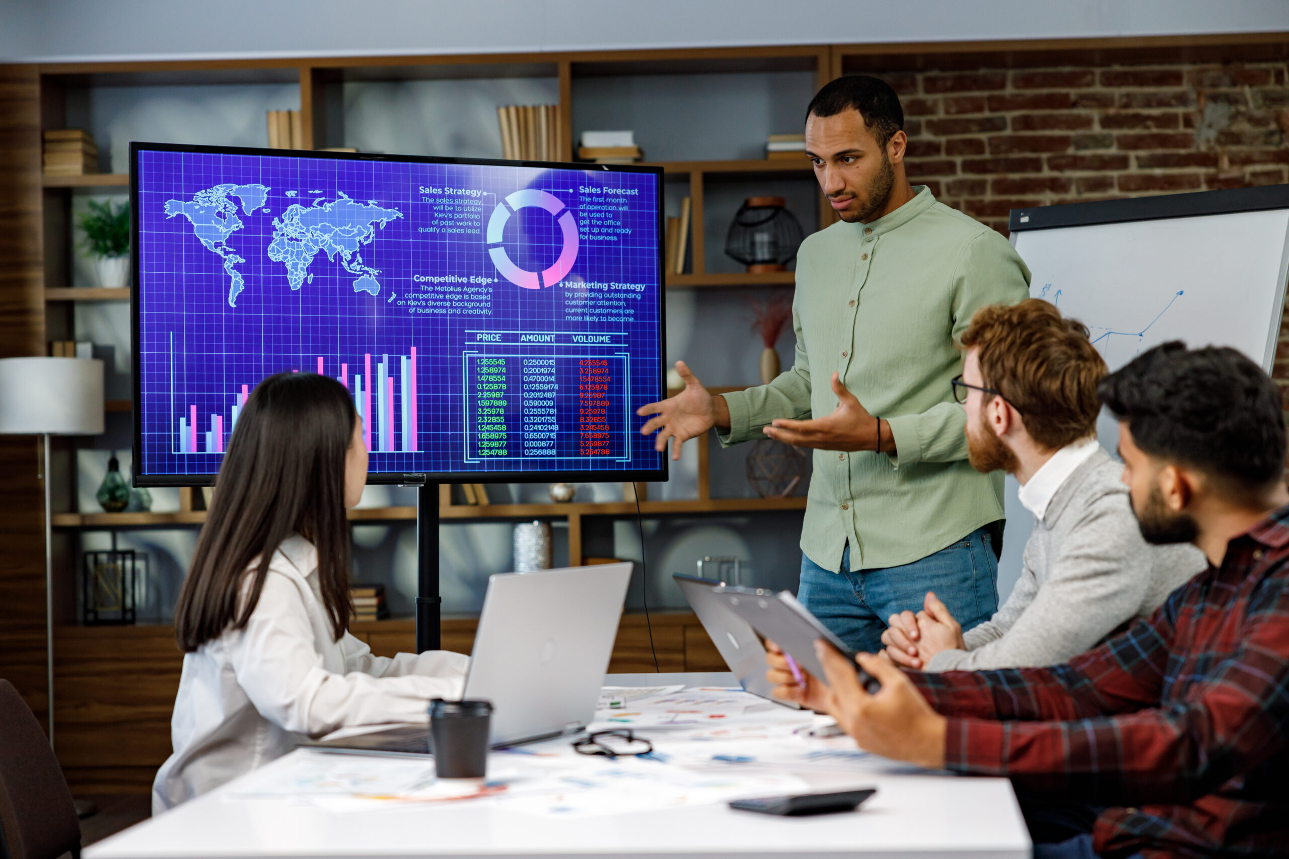 Business team reviewing predictive revenue analytics and sales forecasting data during a RevOps strategy meeting.