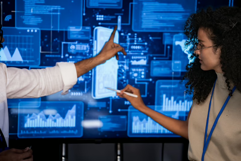 Business professionals analyzing digital dashboards and connected data for AI-native revenue intelligence.